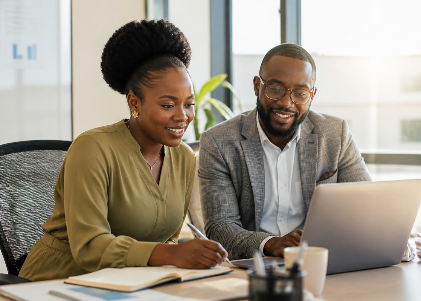 Two African professionals reviewing job matches and interview feedback together on a laptop